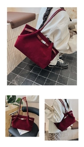 Detail view of burgundy faux suede bucket bag with leather straps and metal buckle decoration