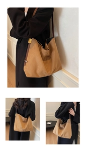 Detail view of large camel suede tote bag with brown leather straps and gold buckle