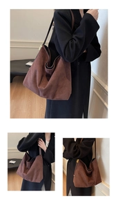 Detail view of large brown faux suede tote bag showing soft texture and premium shoulder strap