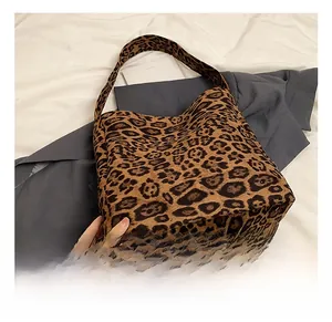 Detail view of the leopard print tote bag featuring heavy fabric texture and wide strap