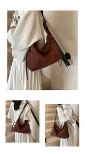 Macro view of vintage brown suede shoulder bag showing textured material and gold zipper detail