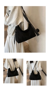 Detailed view of black matte suede hobo shoulder bag with zipper and drawstring details