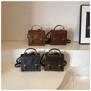 Four retro PU leather satchels in brown, coffee, black, and grey on display