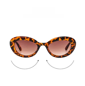 Close-up of retro tortoiseshell oval sunglasses with brown gradient lenses and fine texture