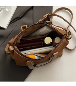 Top view of spacious interior of brown crossbody bag showing large storage capacity