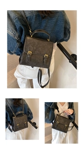 Detail of vintage dark brown faux leather backpack with double buckle straps and top handle