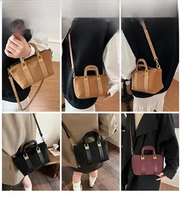 Detail view of stylish striped tote bag in brown, black and burgundy options