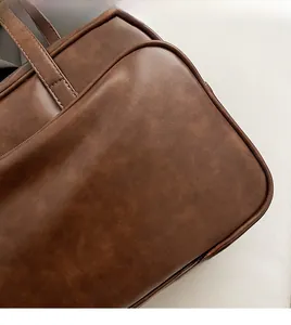 Close-up of matte dark brown leather texture with silver Rioa & Luxury BAGS logo