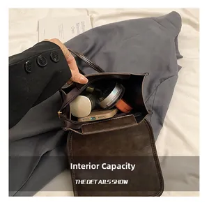 Interior view of the vintage brown crossbody bag showing storage for phone and makeup