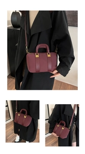 Detail of burgundy leather tote bag with gold hardware and removable shoulder strap