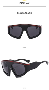 Detail of Y2K sports sunglasses with oversized black frames and red stripe accents