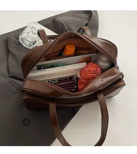 Spacious interior of brown Boston bag showing large capacity for umbrella and wallet