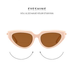 Close-up of pink cat eye sunglasses with sharp frame lines and brown tinted lenses