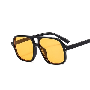 Retro double-bridge aviator sunglasses with black frame and translucent yellow lenses