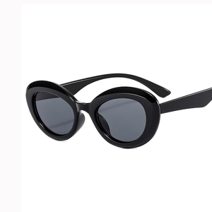 Classic oval cat-eye sunglasses in glossy black frame with dark grey tinted lenses