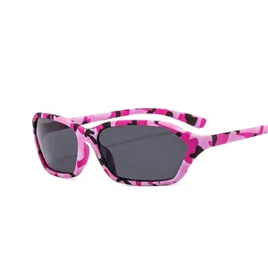 Y2K millennium style sunglasses with pink camouflage polygon frames and dark gray lenses