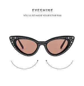 Close-up of cat-eye sunglasses with rhinestone edges and star details on black frames