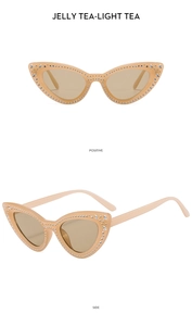 Detail view of cat eye sunglasses with star rhinestones in jelly tea light tea finish