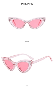 Detail view of pink cat eye sunglasses with star rhinestones showing front and side angles