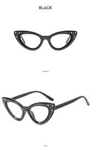 Detail of black cat-eye glasses frame with silver rhinestones and star decorations
