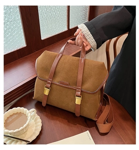 Brown frosted leather satchel with dual decorative straps and wide shoulder strap
