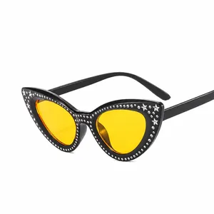 Cat eye sunglasses with yellow lenses, black frames, star accents and rhinestones