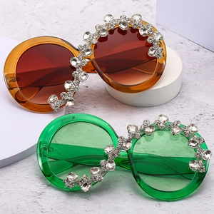 Oversized round sunglasses with luxury crystal rhinestones in amber and emerald green