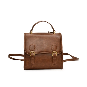 Retro brown PU leather backpack for women with top handle and decorative buckles