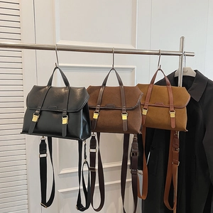 Three vintage satchels in black and brown with suede detail and striped canvas straps