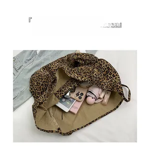 Interior detail of large leopard print tote bag showing storage capacity for daily essentials