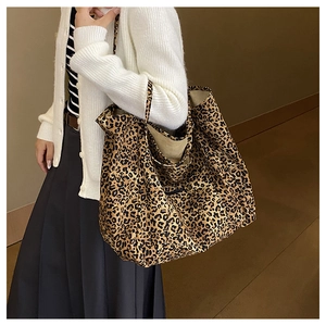 Large capacity leopard print tote bag shown on shoulder for daily commute style