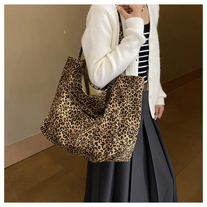 On-body view of a large leopard print tote bag styled with a casual autumn outfit
