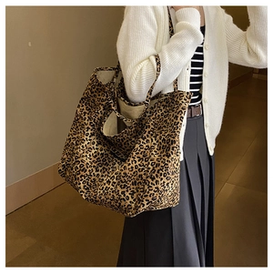 Macro view of leopard print canvas tote bag showing textured material and shoulder strap