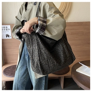 Leopard print tote bag with large capacity shown in a stylish professional setting