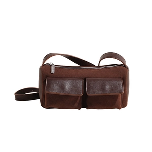 Close-up of suede and leather textures on coffee brown bag with metal zippers