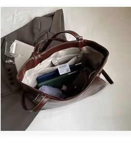 Spacious interior of a vintage brown leather tote bag with functional zipper pocket