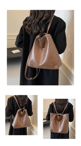 Detail view of large dark brown leather tote bag showing shoulder strap and soft bucket shape