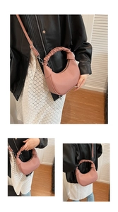 Pink crescent moon bag detail with pleated texture, silver hardware and handle
