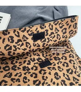Detail of leopard print bag featuring a secure hook and loop fastener for easy access