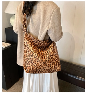 Detail view of large leopard print bucket bag with soft texture in a modern interior
