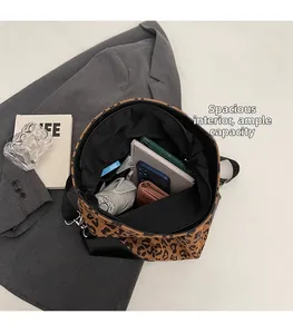 Interior view showing the large capacity of the leopard canvas bucket bag with essentials