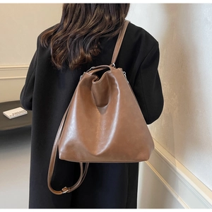 Detail view of brown vintage leather shoulder bag showing the supple texture and strap
