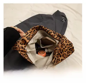 Internal view of leopard print canvas tote showing spacious compartment and inner pocket