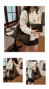 Detail of dark brown leather tote bag with a small bear pendant and matching pouch