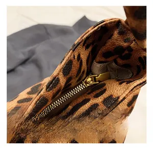Macro shot of high-quality gold metal zipper on leopard print canvas tote bag detail
