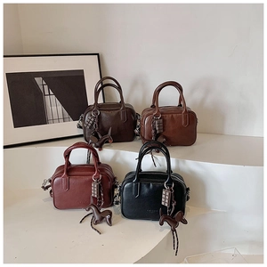 Four leather Boston bags in coffee, caramel, wine red, and black with cute horse charms