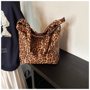 Detailed view of the leopard print canvas tote bag with smooth texture and soft structure