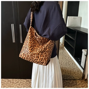 Detailed back view of a large leopard print canvas tote bag styled with casual outfit