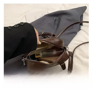 Detail of spacious dark brown leather Boston bag showing interior capacity and lining