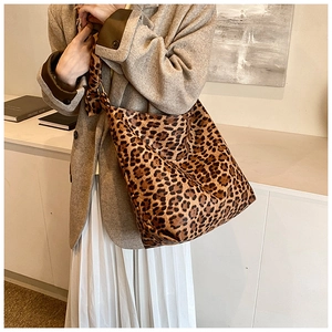 Detailed close-up of leopard print shoulder bag featuring a stylish decorative bow strap